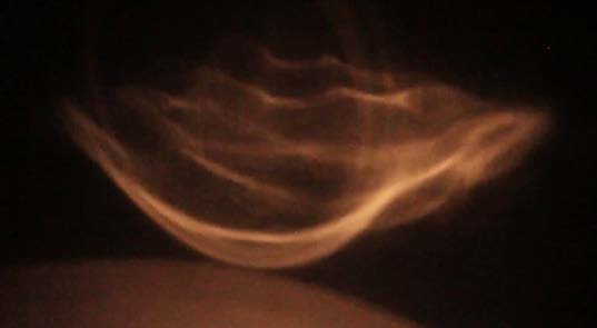 God’s Speck, first of three photographs: light folded like a wing.