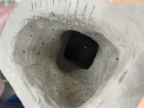 The hollow interior of the ceramic piece.