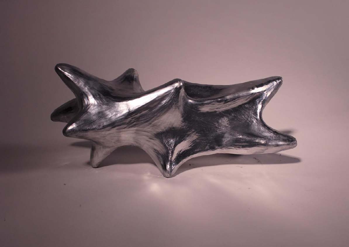 Magnolia, metalized ceramic, turning across its four sides.